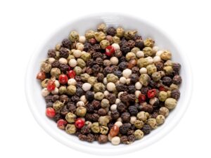 Bowl of white , green and black peppercorns