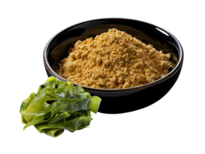 Brownish colored powder in a black bowl beside a green kale leaf.
