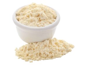 A bowl of white protein powder beside a heap of protein powder