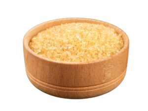 Yellowish crystals in a wooden bowl