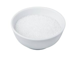 White, small crystals that resemble sugar, in a white bowl.