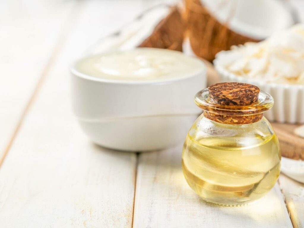 coconut oil and a bowl of coconut oil on a white wooden table