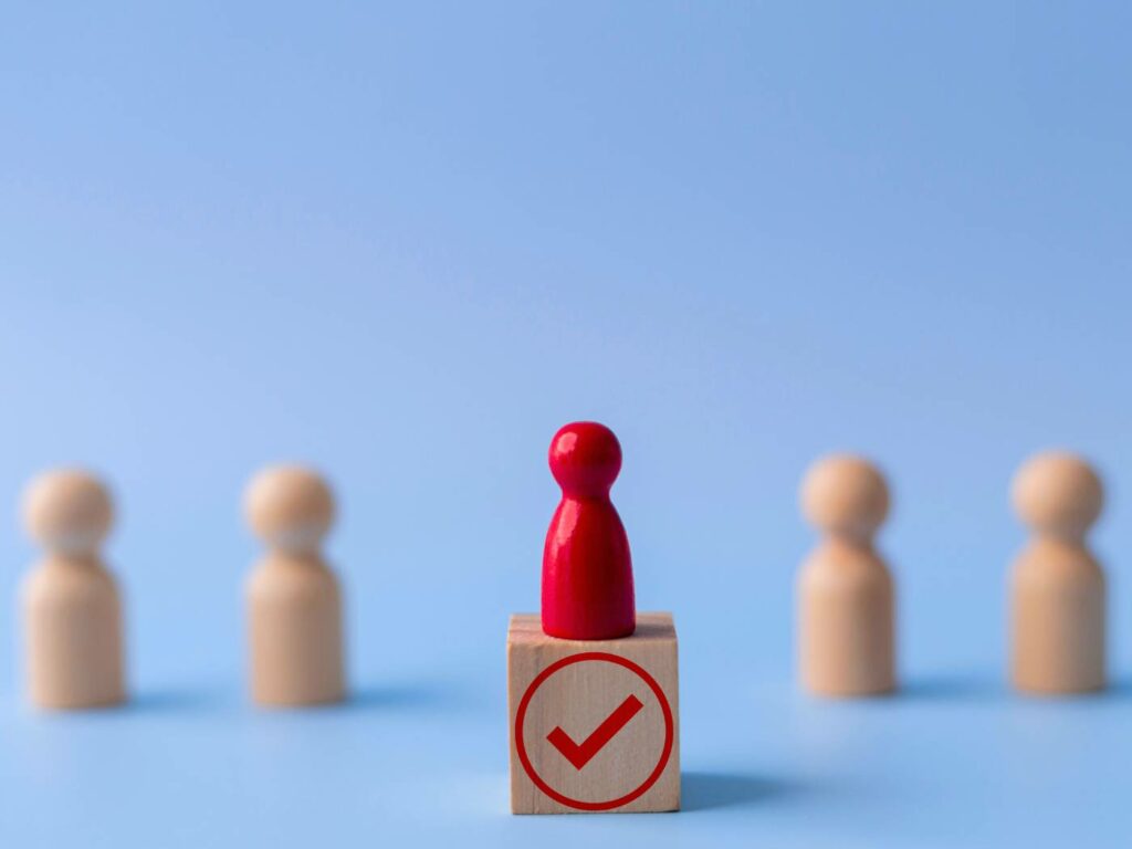 a wooden figure standing in front of a group of people.