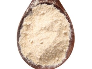 Top view of ivory colored powder on a wooden spoon.