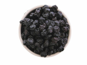 Dark, dried berries in a bowl shown from the top view.