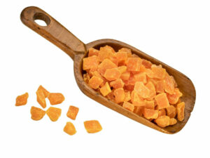 Dry , diced mango in a scooper