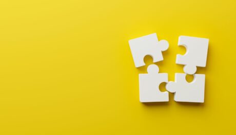 four pieces of puzzle on a yellow background