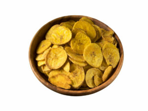 Top view of golden . dry plantain chips in a bowl.
