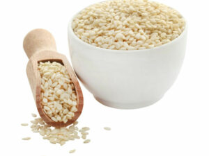 Hulled poppy seeds in a whiite bowl.