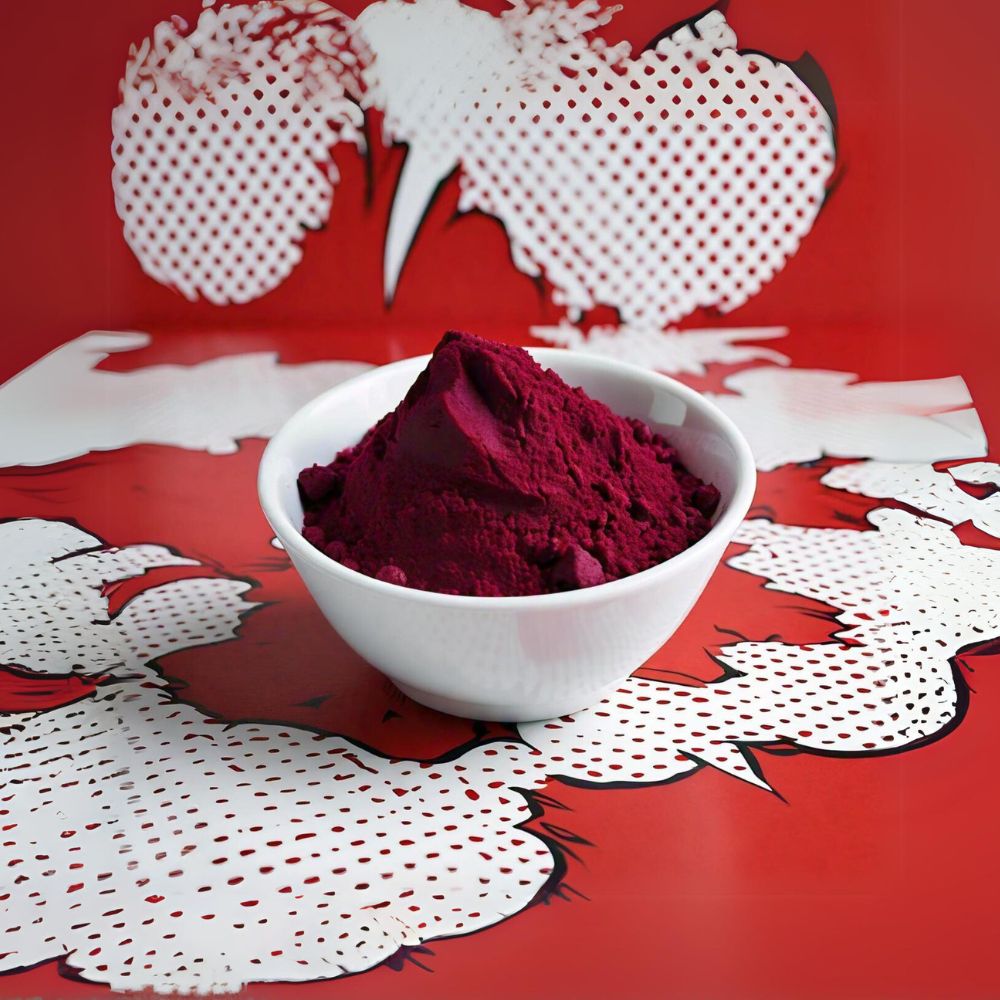 Beetroot powder on a white bowl with a pop art red & white background.