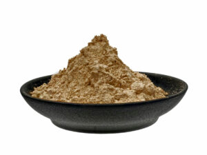 Dark brown powder heaped on a plate.