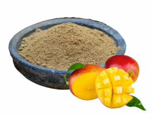 Light brown powder in a bowl displayed with some mango,