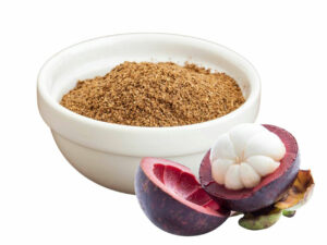 Brown powder in a bowl beside mangoteen fruit.