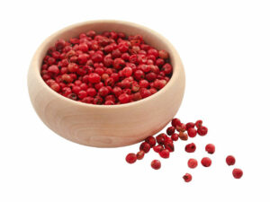 Pink , round seeds in a wooden bowl