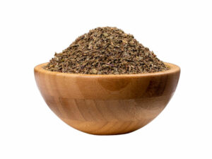 Dry, green brown , crushed leaves in a wooden bowl.