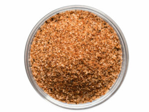 Top view of red white granules in a bowl.