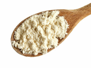 Top view of white powder displayed on a wooden spoon.