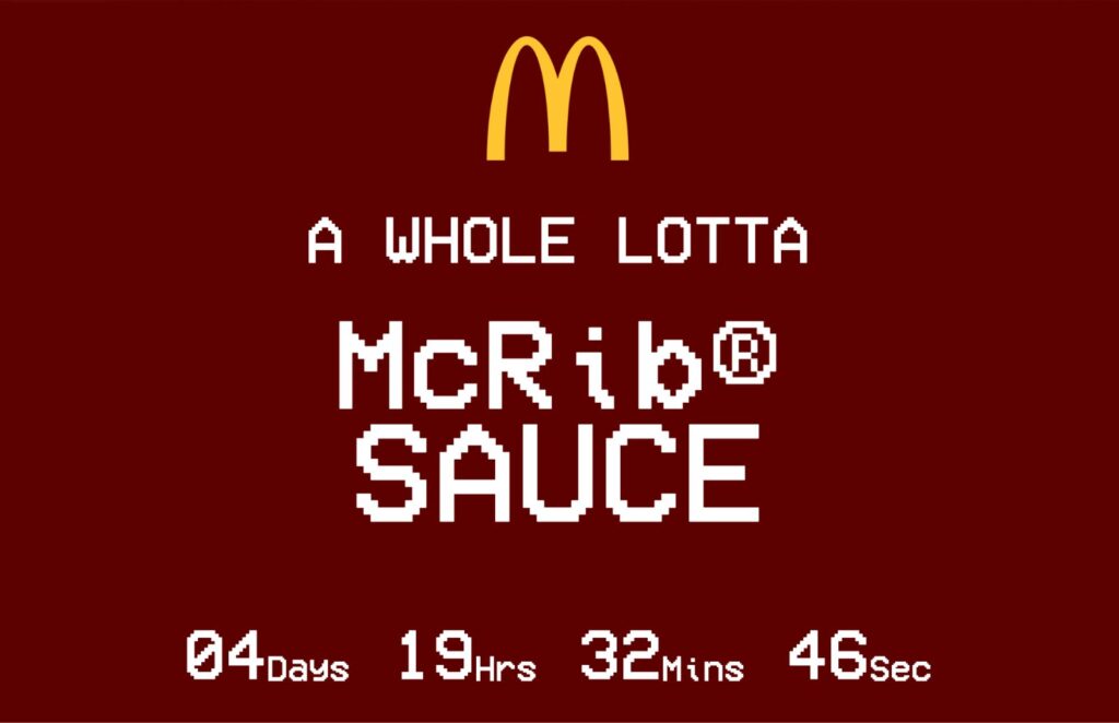 Deep red background with McDonald's yellow arches logo and whit4e letters that read a whole lotta McRib Sauce 04 days 19hrs 32mins 46secs