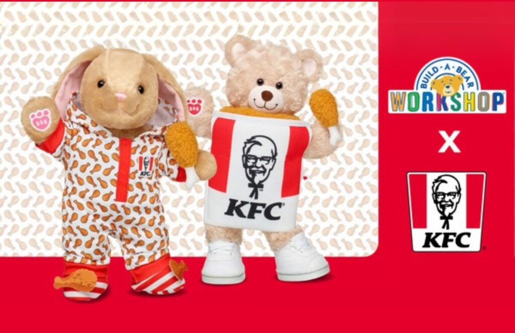 a stuffed bunny dressed with a chicken pajama and a stuffed bear dresses as a chicken bucket.