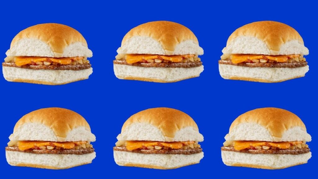 Close-up of White Castle cheddar bacon cheese sliders with melted cheddar and bacon pieces