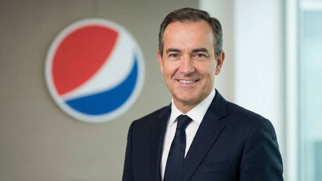 Ramon Laguarta, Chairman and CEO of PepsiCo, speaking at a corporate event with the PepsiCo logo in the background.