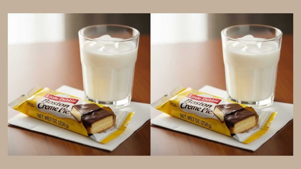 A lifestyle image of a Little Debbie Boston Creme Pie snack sitting on a napkin next to a glass of milk, highlighting the rich chocolate coating.