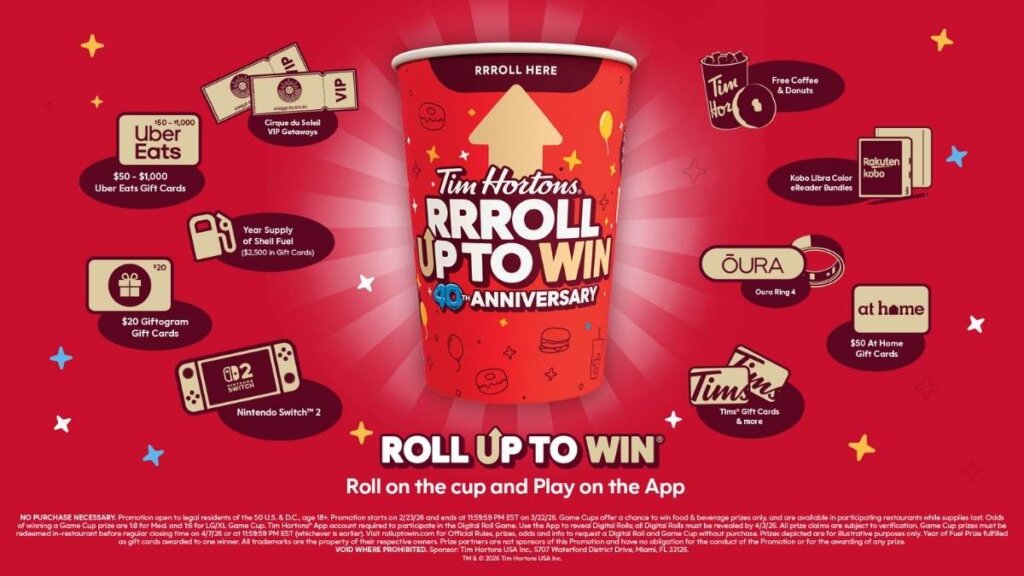 A close-up of a hand rolling up the rim of a red Tim Hortons promotional cup, revealing a "Winner / Gagnez" message under the lip.