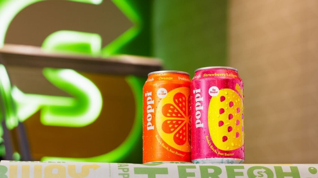 Subway introducing poppi prebiotic soda in Strawberry Lemon and Orange flavors at participating Subway restaurants nationwide starting May 6 2026 featuring 5 grams of sugar per can made with apple cider vinegar and fruit juice