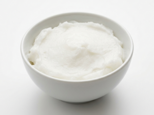 Coconut Oil on a white ceramic bowl with a white background