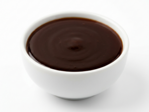 Date Syrup on a white ceramic bowl over a white background