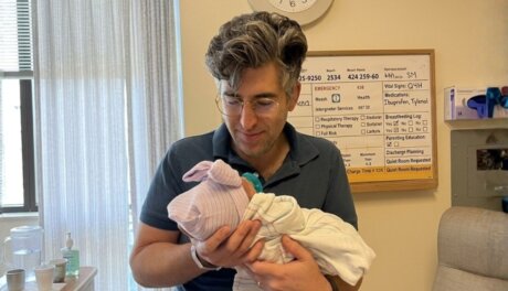 Eran holding her new born at the delivery room